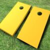 yellow painted cornhole set